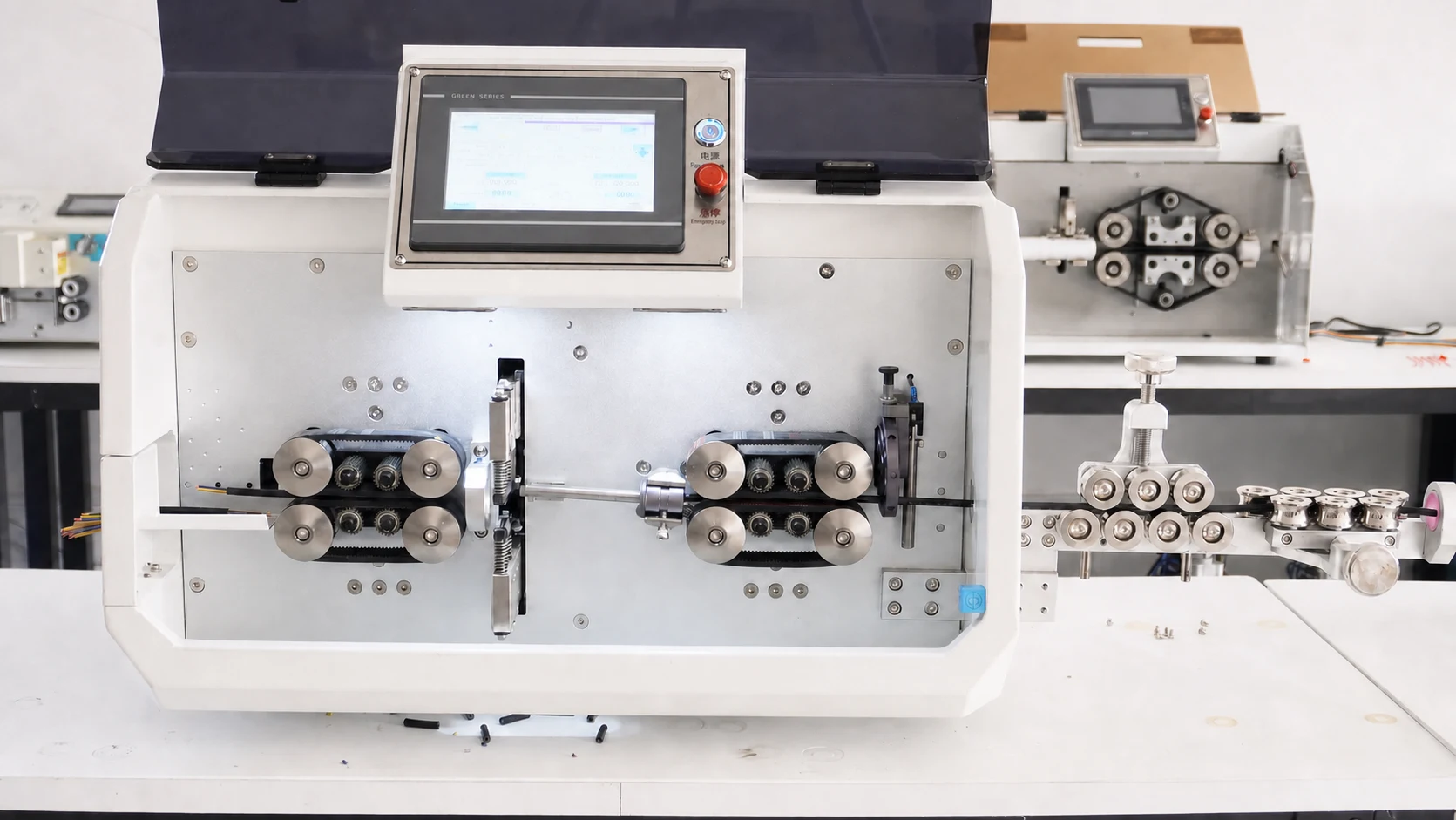 Cable-processing machine used on Kinishi's cable assembly line, showing its feed rollers and cable path.